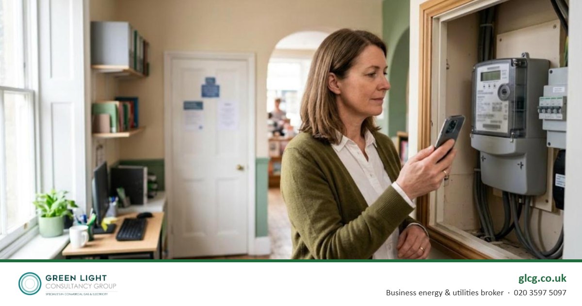 Business owner checking a commercial electricity meter with a smartphone to find the energy supplier